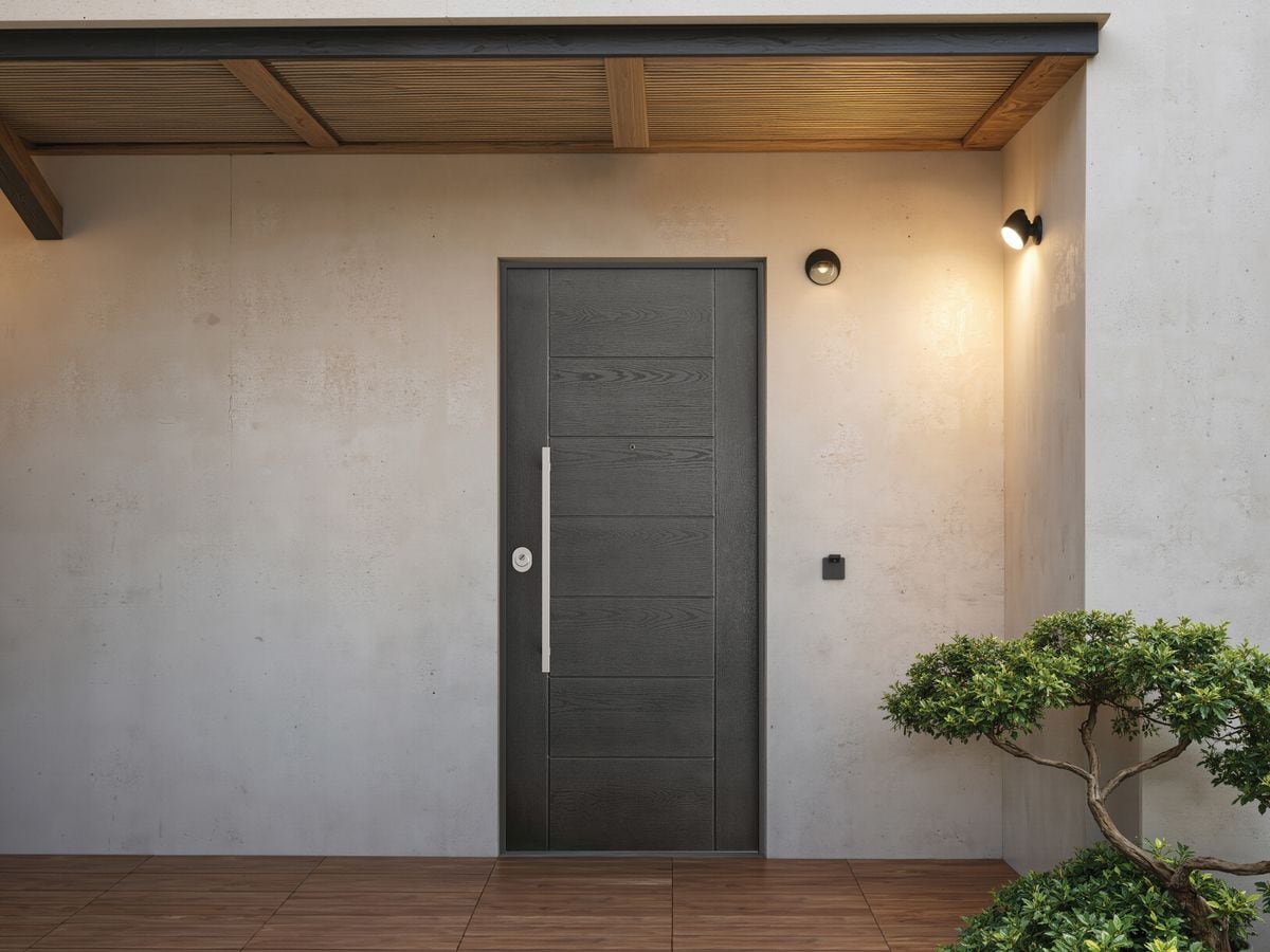 Porte blindée gris anthracite à lignes horizontales, sous un auvent en bois